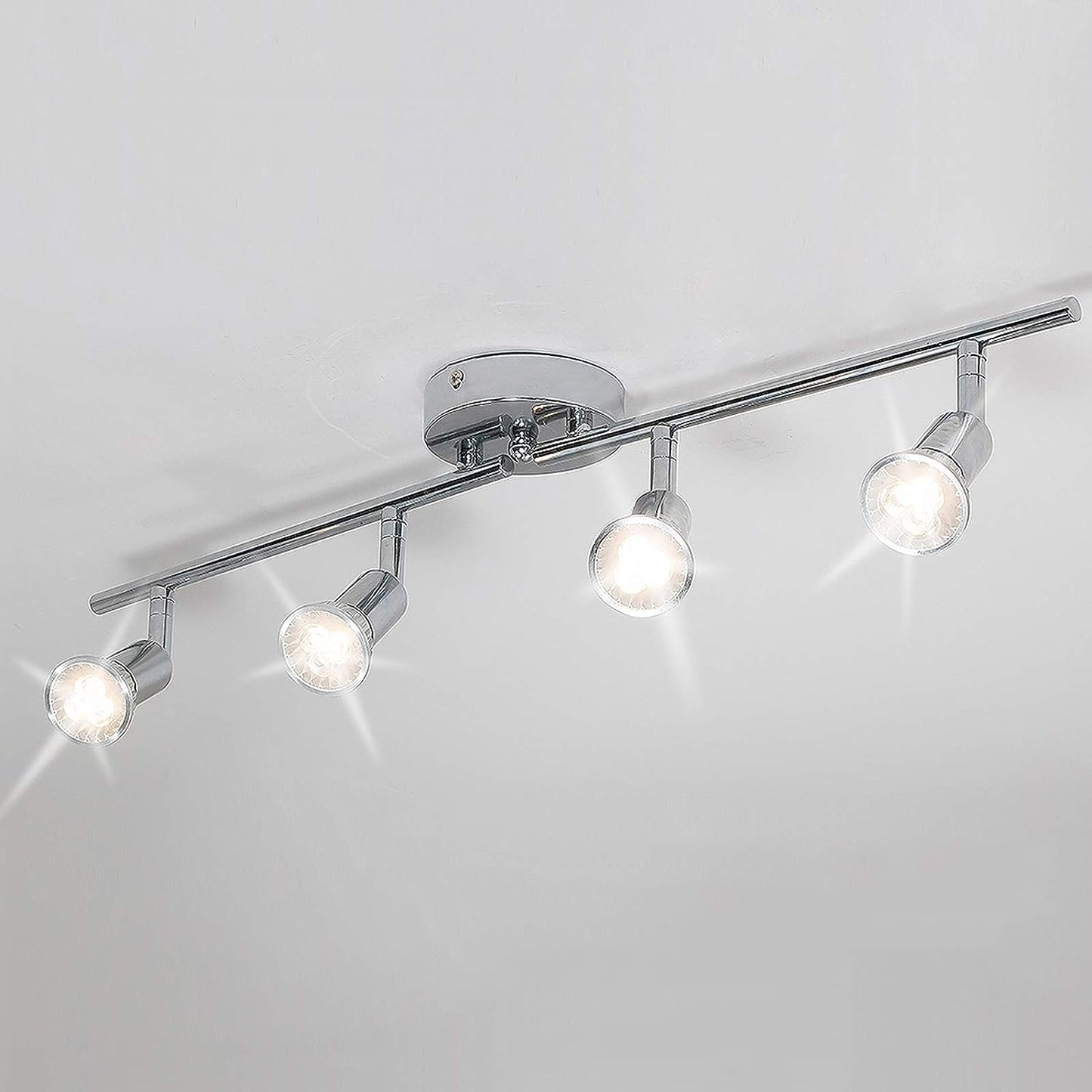 Ceiling light fixture with four spotlights on a white ceiling