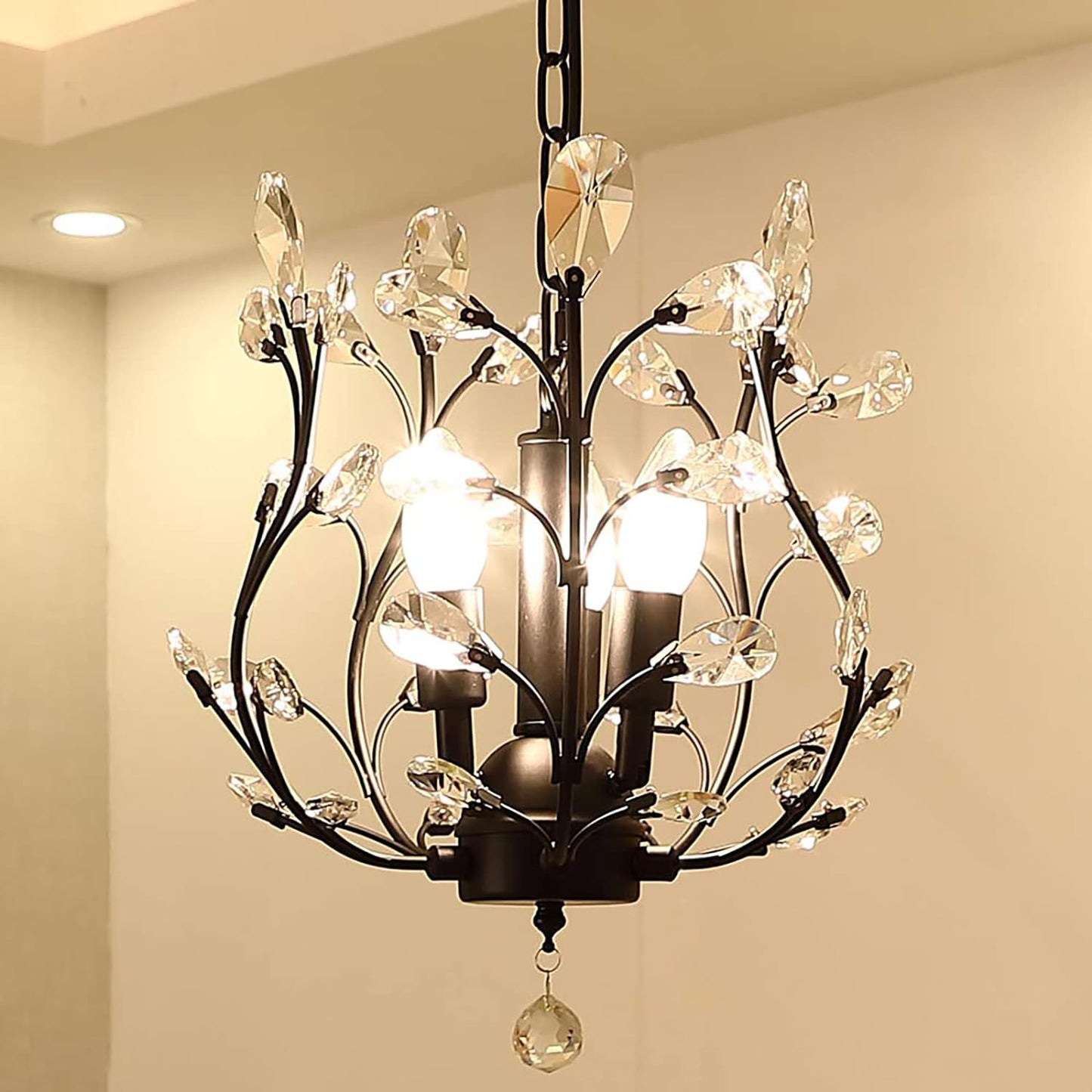 Decorative vintage style 3 light chandelier with crystal accents dark chocolate finish on a beige wall background