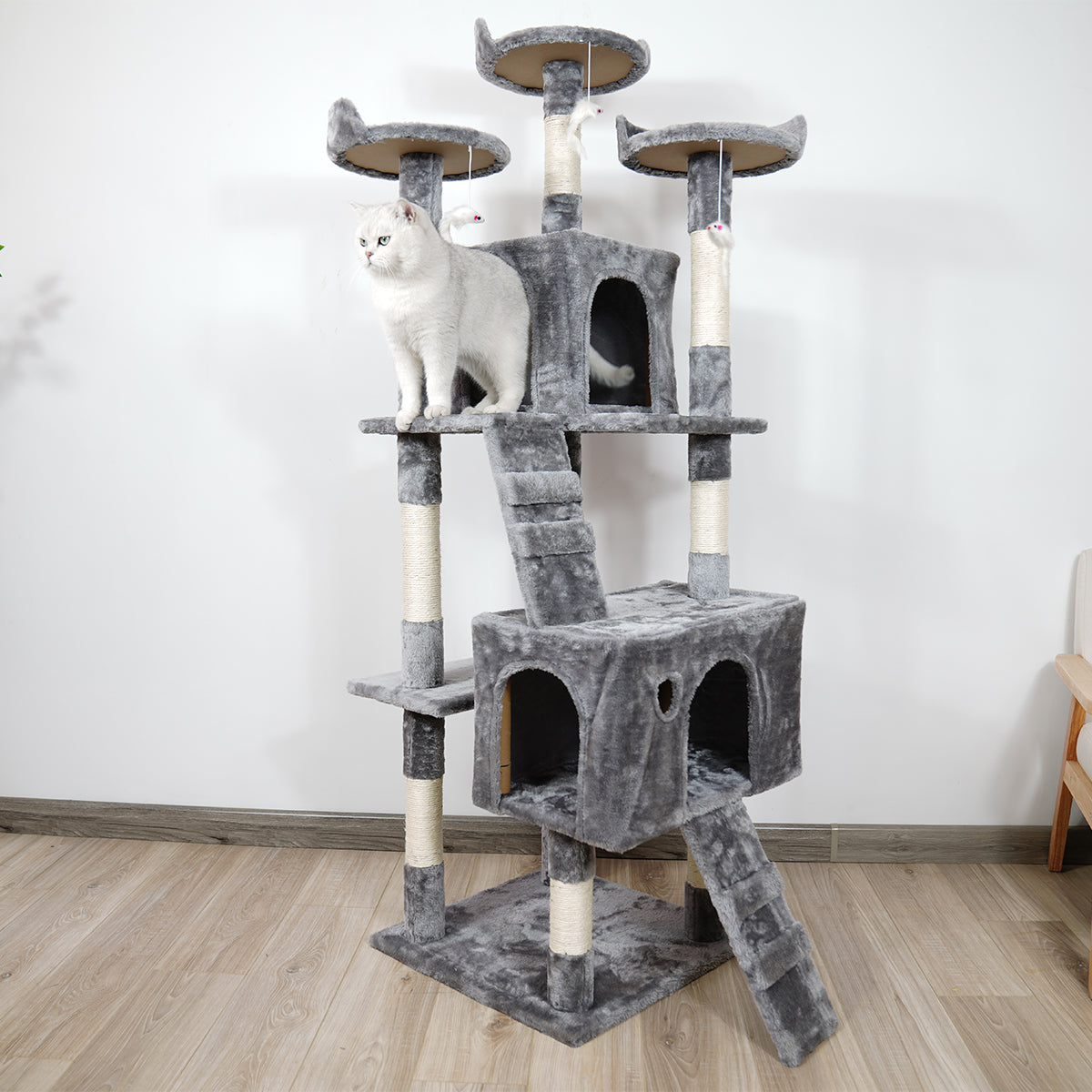 Cat tree with multiple levels and a cat perched on one of the platforms.