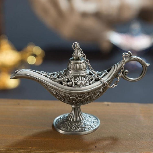 Decorative silver lamp on a wooden surface with a blurred background